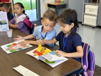 Kindergarten students in Mark Twain Elementary’s Dual Language Immersion program engage in hands-on instruction and learning, diving into bilingual books in a multicultural setting.