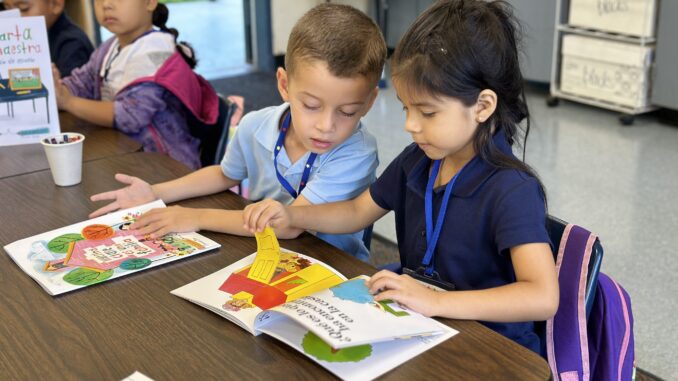 Kindergarten students in Mark Twain Elementary’s Dual Language Immersion program engage in hands-on instruction and learning, diving into bilingual books in a multicultural setting.